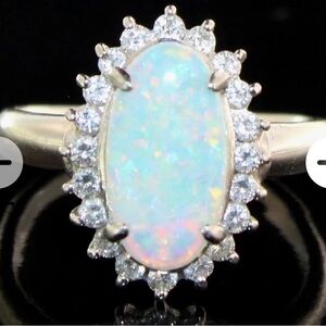 Natural opal weighing 1.21 carats Natural Diamonds Carat weight: .42 Color Grade